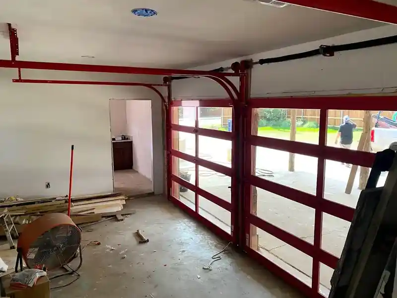 Red full view glass garage door interior view with track system