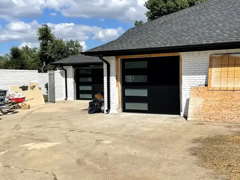Modern black garage door with glass panels installation