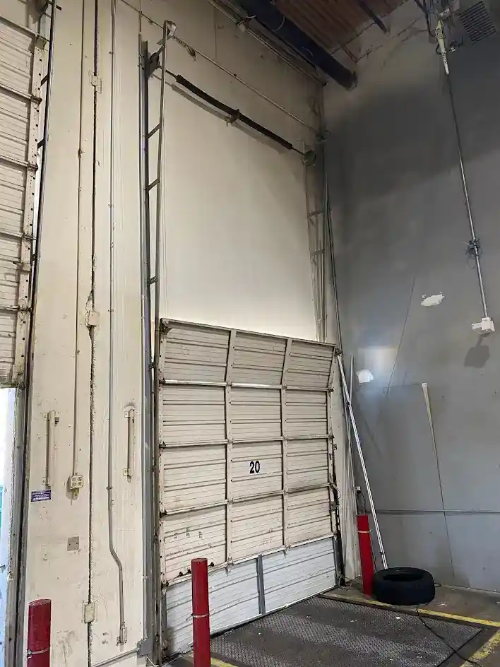 Commercial overhead door repair at warehouse loading bay in Garland TX