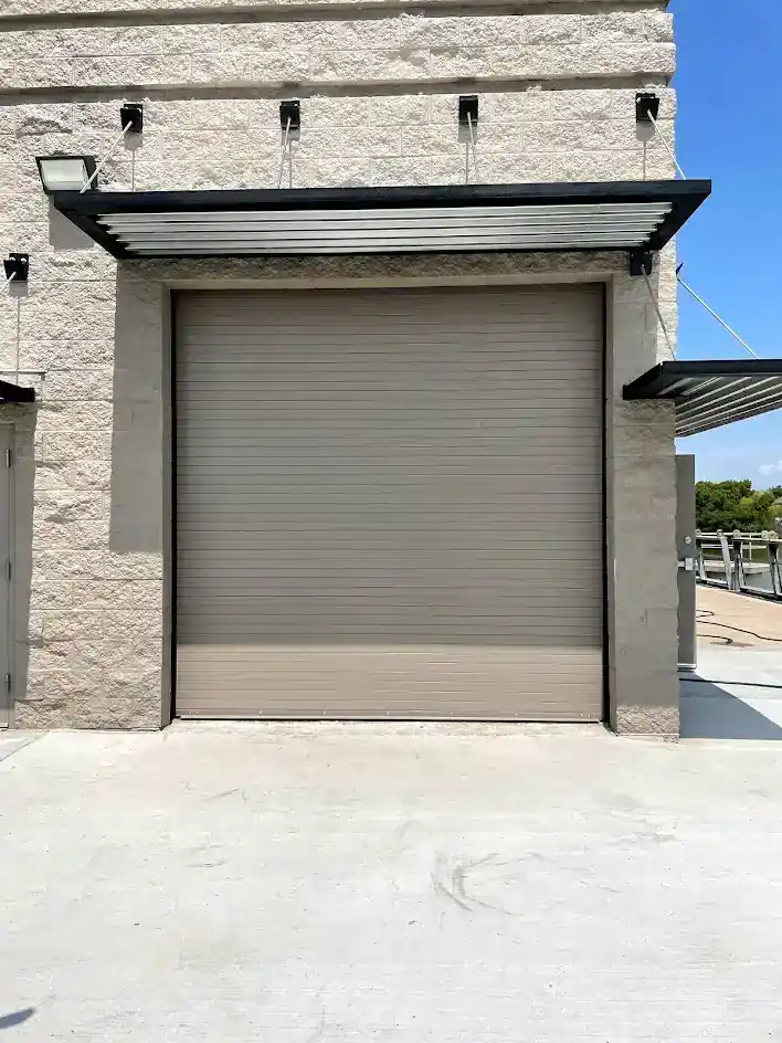 Tan rolling steel door finished installation at Dallas facility